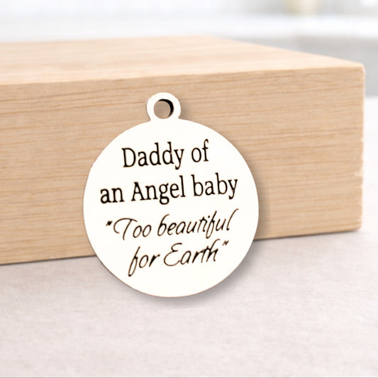 White pendant with engraved text on a wooden block