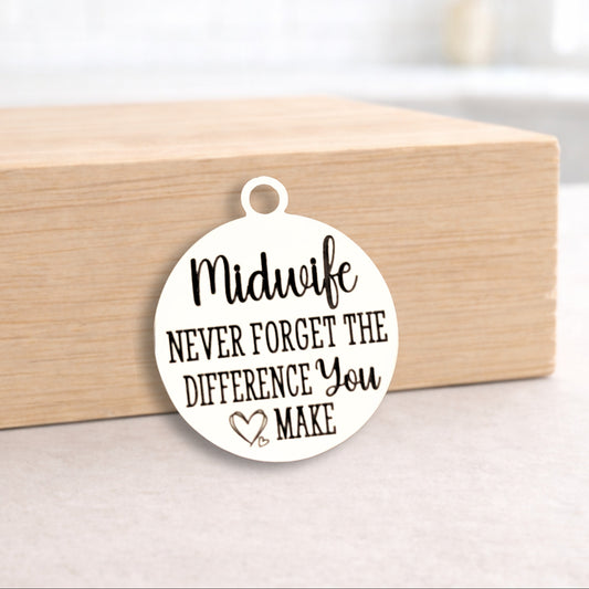 Round pendant with 'Midwife Never Forget the Difference You Make' text on a wooden block.