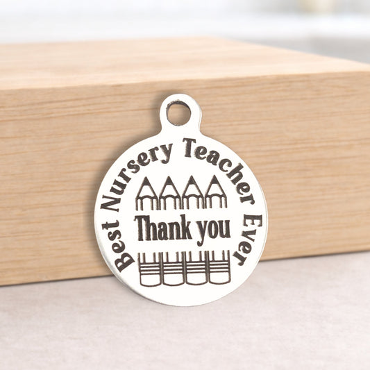 Silver pendant with 'Best Nursery Teacher Ever Thank you' text on a wooden block.