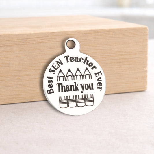 Silver pendant with 'Best SEN Teacher Ever Thank you' text on a wooden block.