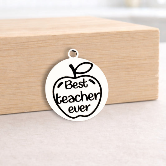 Metallic pendant with 'Best teacher ever' text on a wooden block