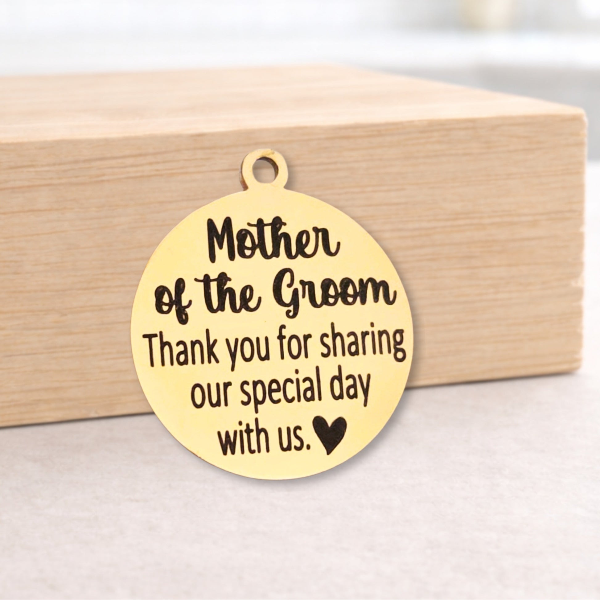 Gold pendant with engraved message on a wooden block