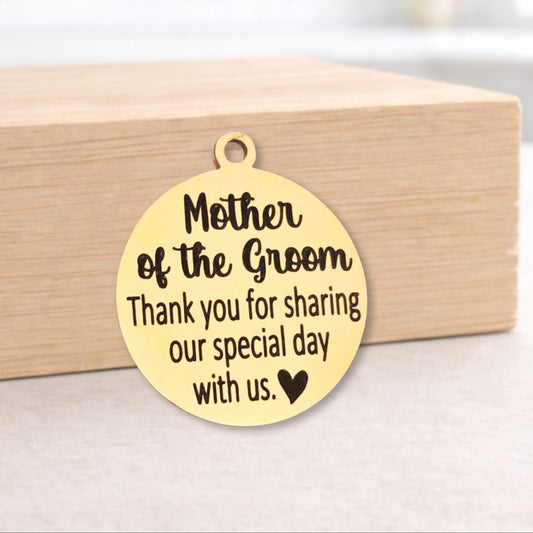 Gold pendant with engraved message on a wooden block