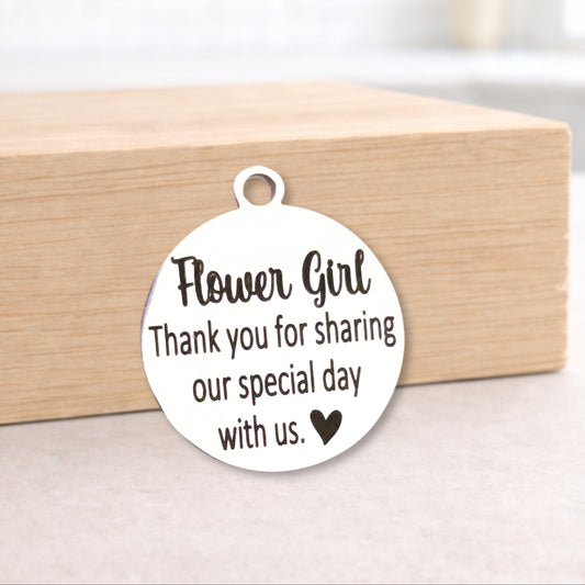 Metal pendant with 'Flower Girl' message on a wooden block