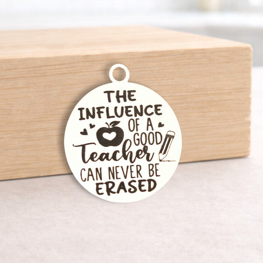 Circular pendant with engraved text on a wooden block