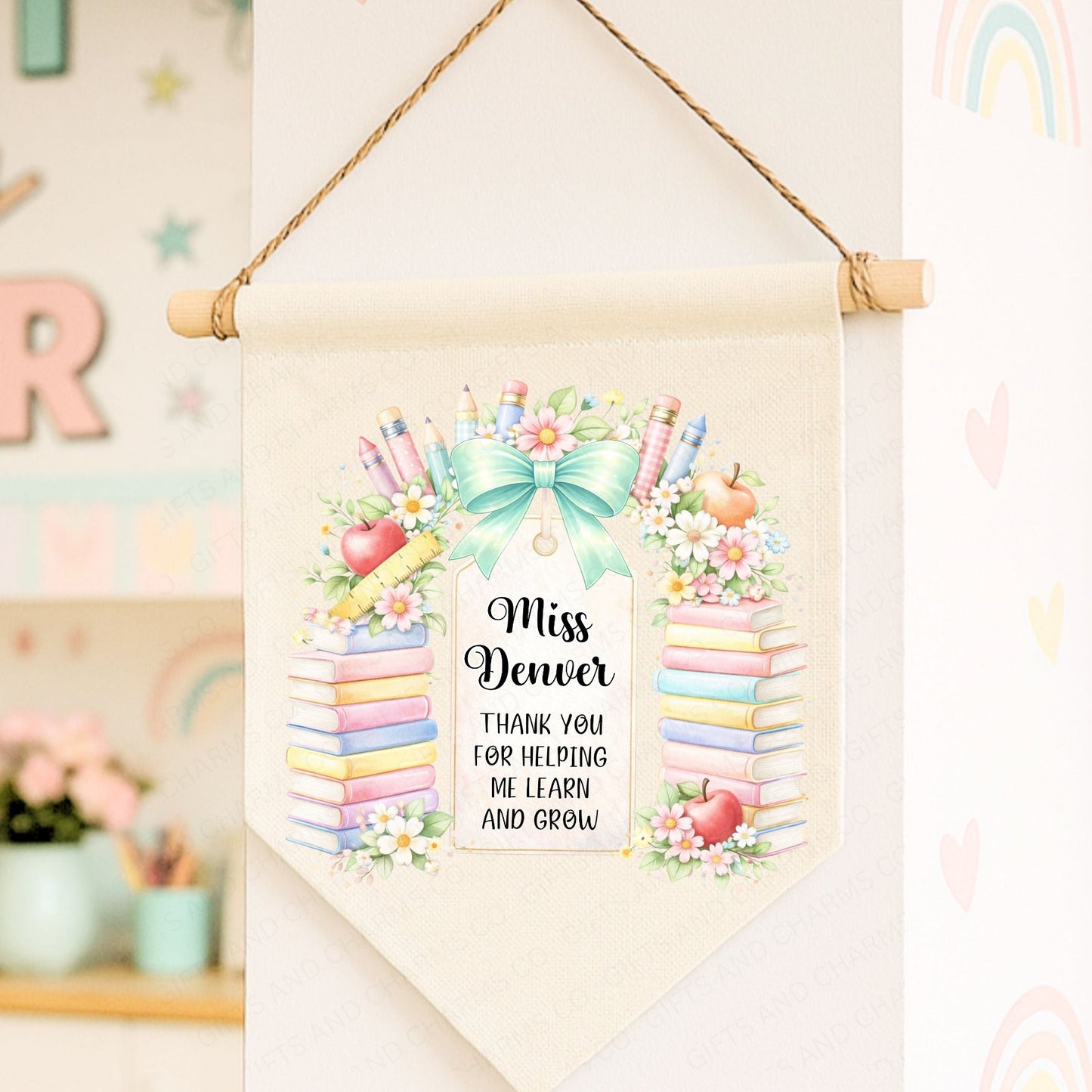 Personalized teacher appreciation banner with colorful design and text, hanging on a wall.