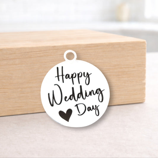 Round white pendant with 'Happy Wedding Day' text on a wooden block