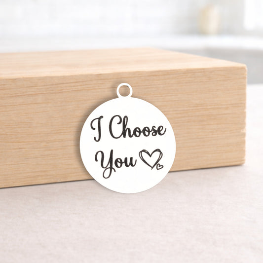 White pendant with 'I Choose You' text on a wooden box