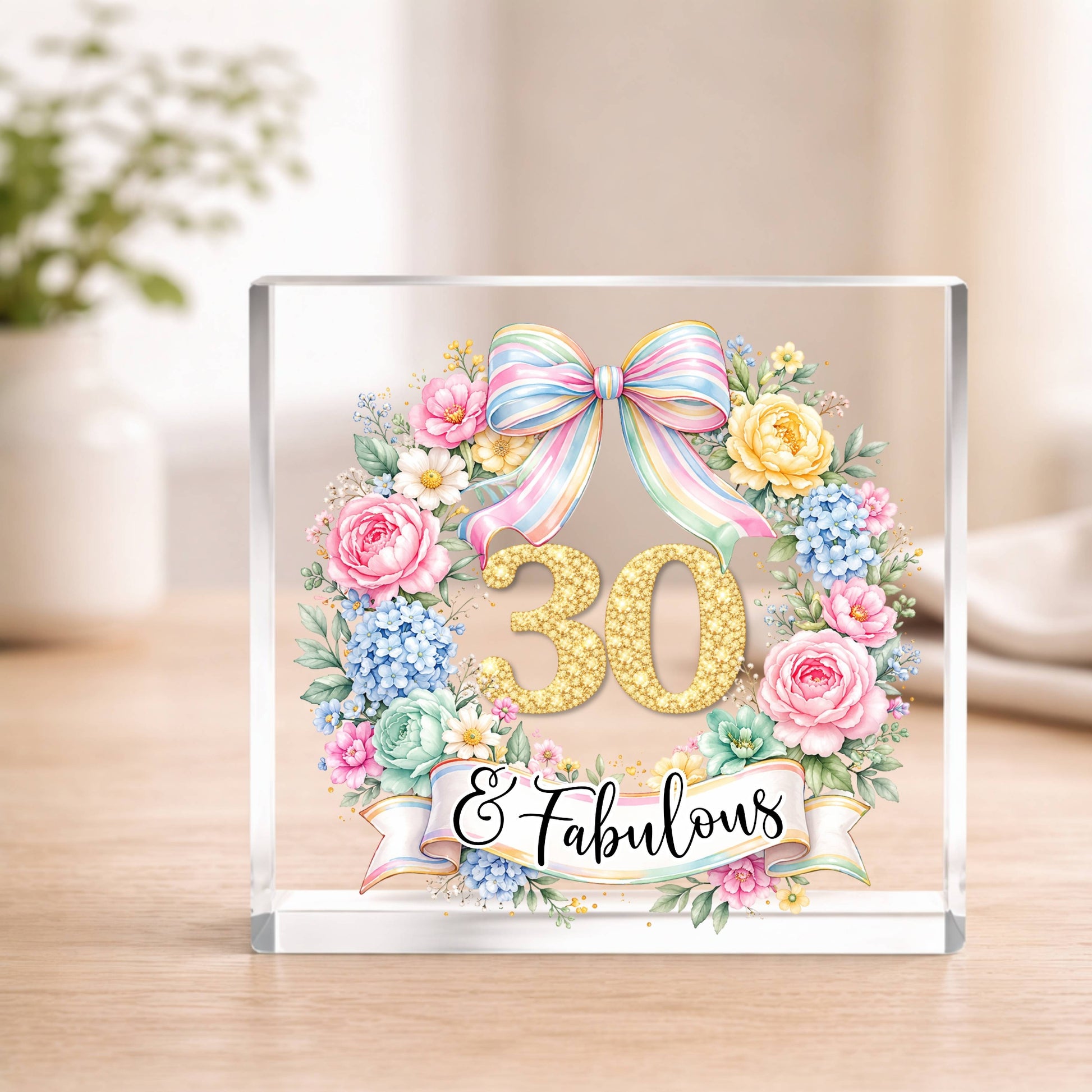 Decorative Acrylic block with '30 & Fabulous' text, flowers, and a bow on a wooden surface.