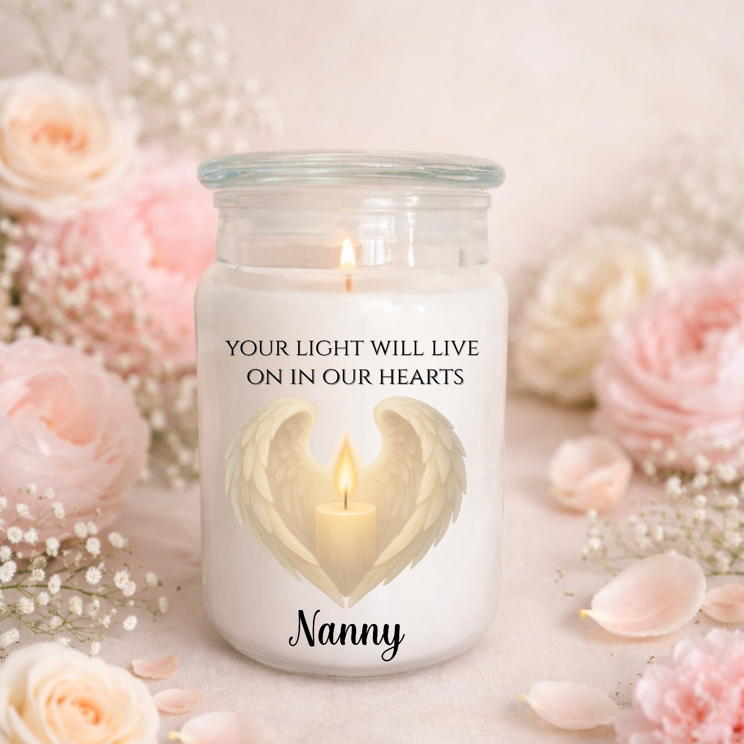 Candle in a jar with 'Your light will live on in our hearts Nanny' text, surrounded by flowers.