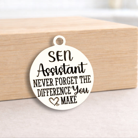 Round white pendant with text on a wooden block