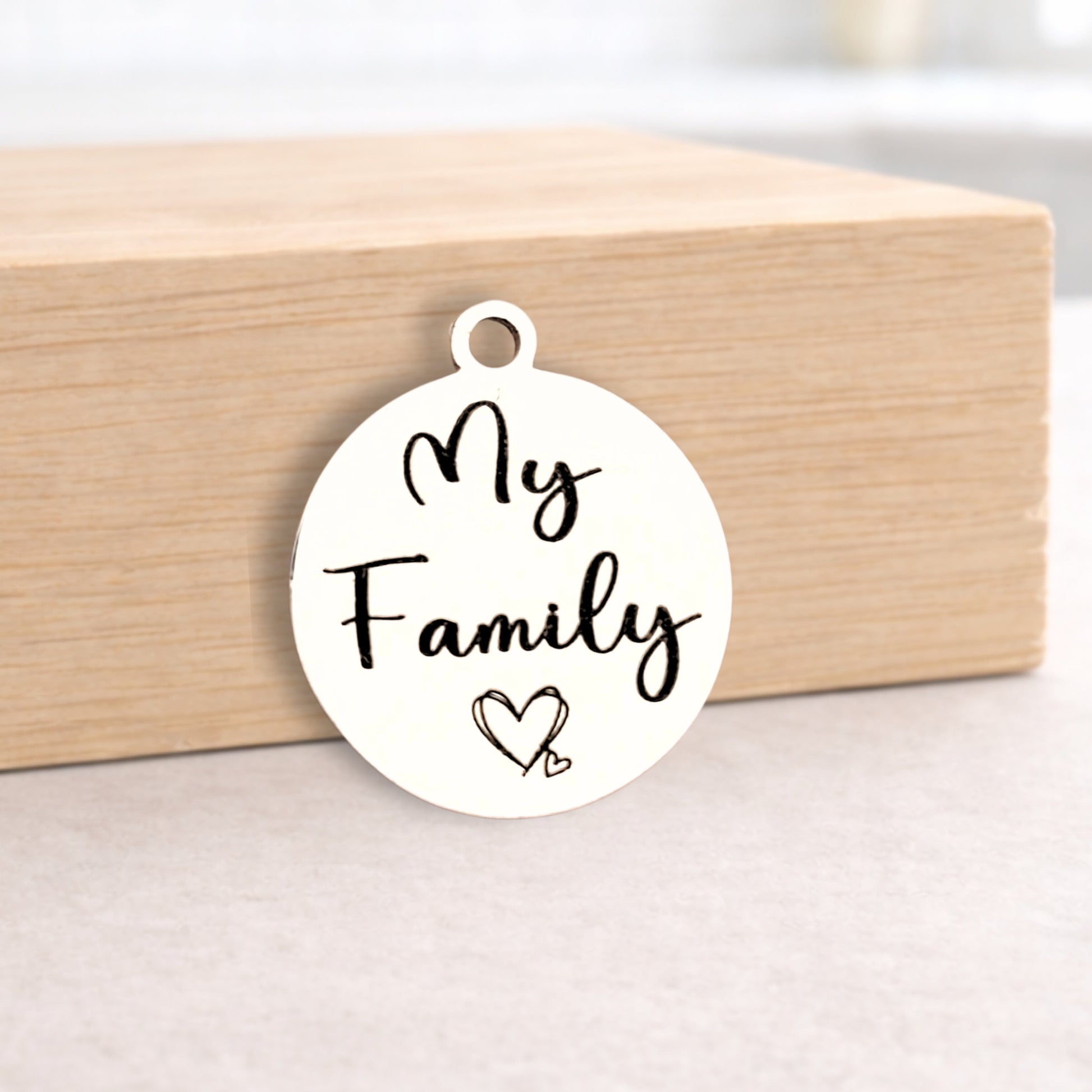 White pendant with 'My Family' and a heart on a wooden block