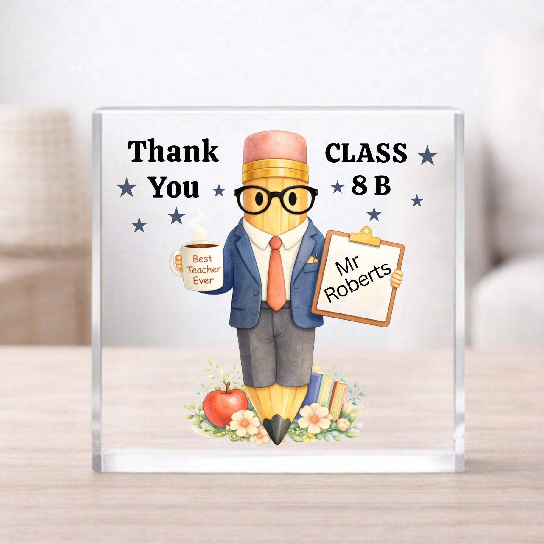 Personalized teacher appreciation gift with a cartoon character holding a sign and a mug, on a light wooden surface.
